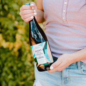 hand holding chardonnay bottle